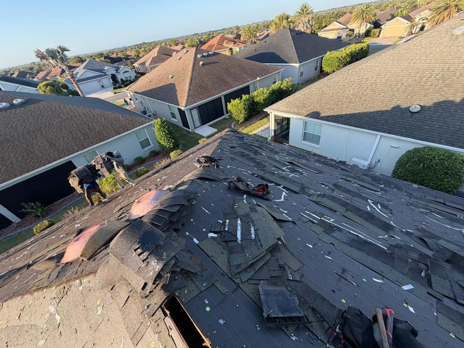 Logams Roofing crew replacing a shingle roof on a Central Florida home
